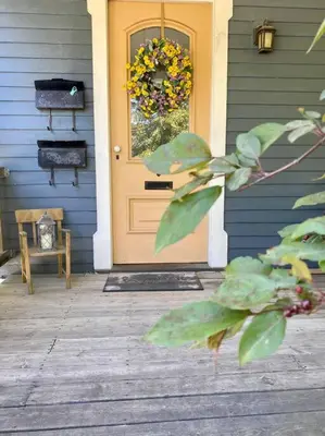 a front door of a house with a wreath on it at Cozy Main Street Flat in Adrian