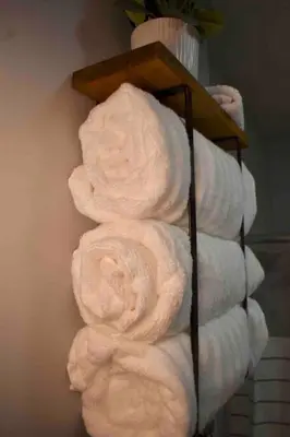 a pile of towels on a rack in a bathroom at Cozy Garden House in Adrian