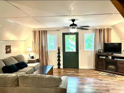 a living room with a couch and a ceiling fan at HOT TUB -Secluded Cabin Cave Run Lake and near Red River Gorge in Wellington