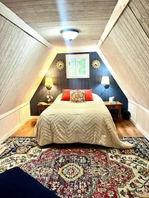 a bedroom with a bed with two tables and a rug at HOT TUB -Secluded Cabin Cave Run Lake and near Red River Gorge in Wellington