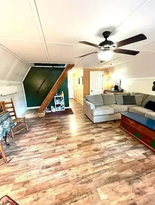 a living room with a couch and a ceiling fan at HOT TUB -Secluded Cabin Cave Run Lake and near Red River Gorge in Wellington
