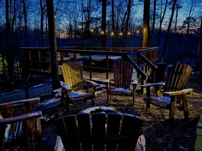 a group of chairs sitting in the woods at night at HOT TUB -Secluded Cabin Cave Run Lake and near Red River Gorge in Wellington
