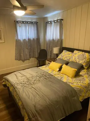 a bedroom with a large bed with yellow pillows at Take me to the River! in Zanesville