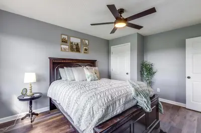 a bedroom with a bed with a ceiling fan at Sprawling Kentucky Getaway with Pool and Hot Tub! in Berry