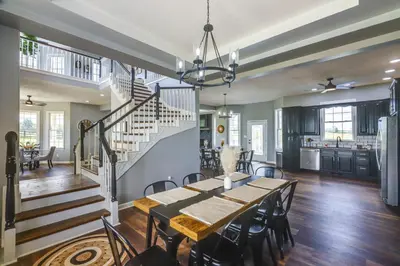 a dining room and kitchen with a table and chairs at Sprawling Kentucky Getaway with Pool and Hot Tub! in Berry