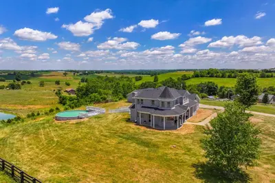an overhead view of a large house on a grass field at Sprawling Kentucky Getaway with Pool and Hot Tub! in Berry
