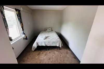 a bedroom with a bed in a room with a window at Hallmark Inn By OYO Fort Wayne in Fort Wayne