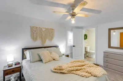 a bedroom with a bed and a ceiling fan at Ohio Farmhouse Retreat with Fire Pit and Patio in Monroeville