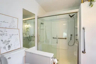 a bathroom with a glass shower and a toilet at North Fairfield Family Home with Hot Tub and Porch! in Willard
