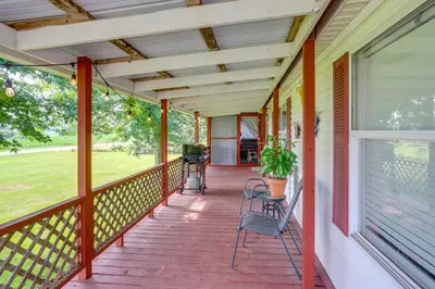 a porch of a house with chairs and a window at North Fairfield Family Home with Hot Tub and Porch! in Willard