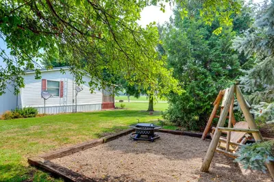 a backyard with a table and a fire pit at North Fairfield Family Home with Hot Tub and Porch! in Willard