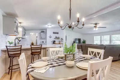 a dining room and kitchen with a table and chairs at North Fairfield Family Home with Hot Tub and Porch! in Willard