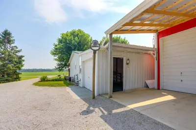 a garage with a red and white building at North Fairfield Family Home with Hot Tub and Porch! in Willard