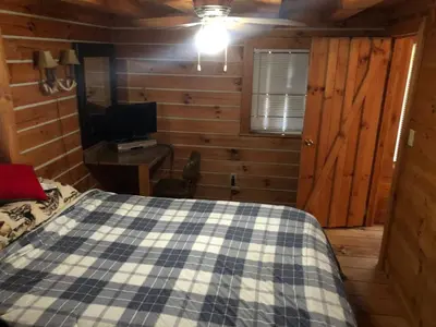 a bedroom with a bed and a desk with a television at Lodge 65AC Zanesville Muskingum AEP WIFI CELL SVC in Blue Rock
