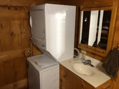 a bathroom with a sink and a washing machine at Lodge 65AC Zanesville Muskingum AEP WIFI CELL SVC in Blue Rock