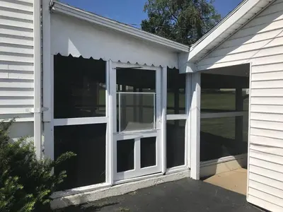 a garage with sliding glass doors on the side of a house at 3BR 1BA North End Walk to the Hospital in Zanesville