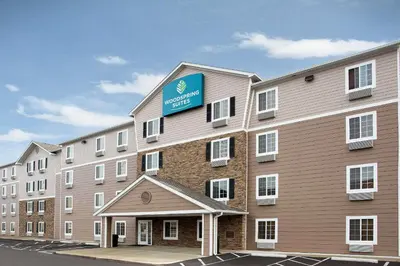 a large building with a sign on the side of it at WoodSpring Suites Columbus North I-270 in Columbus