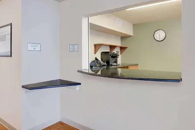 a mirror on the wall of a hospital room at WoodSpring Suites Columbus North I-270 in Columbus