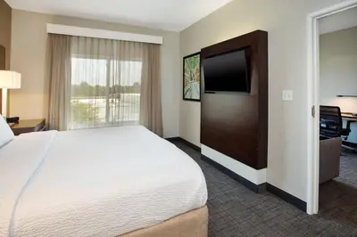 a hotel room with a bed and a flat screen tv at Residence Inn by Marriott Columbus Dublin in Dublin