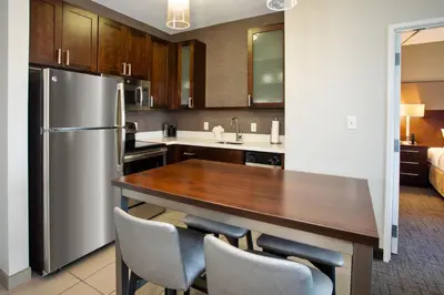 a kitchen with a wooden table and a refrigerator at Residence Inn by Marriott Columbus Dublin in Dublin
