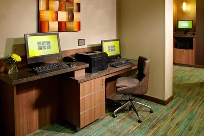 a hotel room with two computer monitors on a desk at Residence Inn by Marriott Columbus Dublin in Dublin