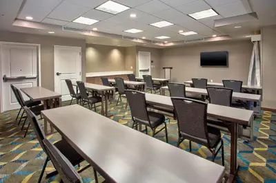 a conference room with tables and chairs and a tv at Residence Inn by Marriott Columbus Dublin in Dublin