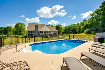a swimming pool in front of a house at Spacious Thornville Home about 8 Mi to Buckeye Lake! in Thornville