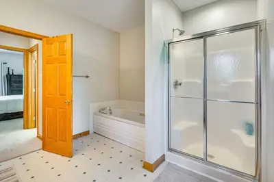 a bathroom with a glass shower and a tub at Spacious Thornville Home about 8 Mi to Buckeye Lake! in Thornville