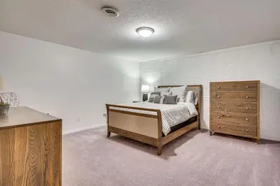 a bedroom with a bed and a wooden dresser at Spacious Thornville Home about 8 Mi to Buckeye Lake! in Thornville