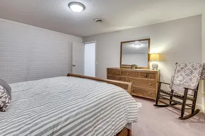 a bedroom with a bed and a dresser and a mirror at Spacious Thornville Home about 8 Mi to Buckeye Lake! in Thornville