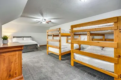 a bedroom with two bunk beds and a desk at Spacious Thornville Home about 8 Mi to Buckeye Lake! in Thornville