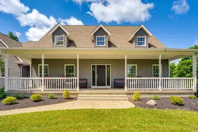 a house with a front porch and lawn at Spacious Thornville Home about 8 Mi to Buckeye Lake! in Thornville