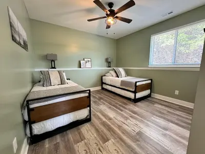 a bedroom with two beds and a ceiling fan at 100 Acre Relaxing Retreat Near ARK- The Cabin in Williamstown