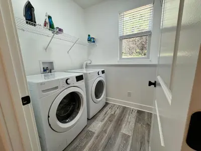 a laundry room with a washing machine and a window at 100 Acre Relaxing Retreat Near ARK- The Cabin in Williamstown