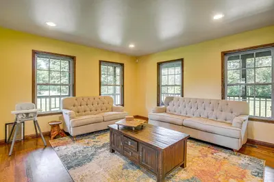 a living room with two couches and a coffee table at Quiet Family Cabin in Hamden Hot Tub and Game Room! in Hamden