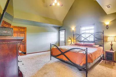 a bedroom with a bed and a piano in a room at Quiet Family Cabin in Hamden Hot Tub and Game Room! in Hamden
