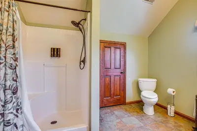 a bathroom with a tub and a toilet and a shower at Quiet Family Cabin in Hamden Hot Tub and Game Room! in Hamden