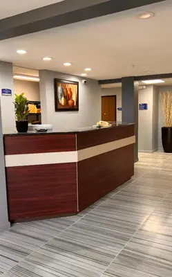a lobby of a hospital with a reception desk at BlissPoint Inn & Suites, Northwood in Northwood