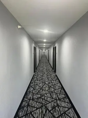a long hallway with a long corridor at BlissPoint Inn & Suites, Northwood in Northwood
