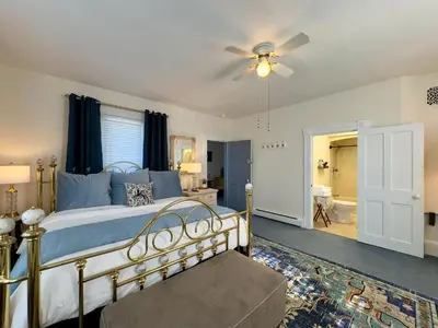 a bedroom with a bed and a ceiling fan at Victorian Inn Bed And Breakfast in Marblehead