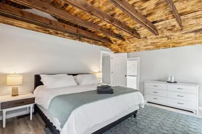 a bedroom with a bed and a wooden ceiling at Spacious Home with Game Room - 9 mins from Cedar Point in Sandusky