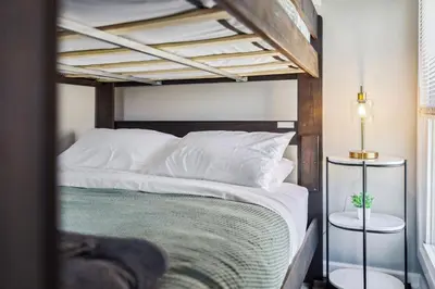 a bedroom with a bunk bed with white pillows at Spacious Home with Game Room - 9 mins from Cedar Point in Sandusky