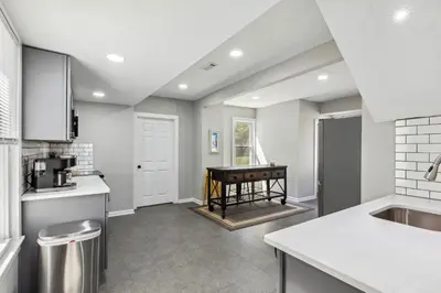 a kitchen with a sink and a table at Spacious Home with Game Room - 9 mins from Cedar Point in Sandusky