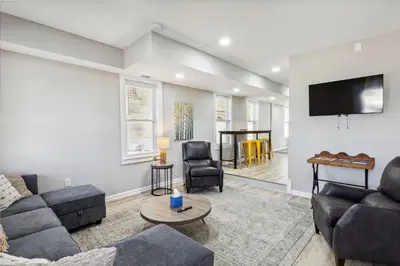 a living room with a couch and a flat screen tv at Spacious Home with Game Room - 9 mins from Cedar Point in Sandusky