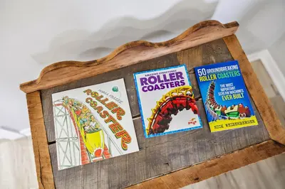 a wooden frame with childrens books and a roller coaster at Spacious Home with Game Room - 9 mins from Cedar Point in Sandusky