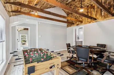 a room with a foosball table and chairs at Spacious Home with Game Room - 9 mins from Cedar Point in Sandusky