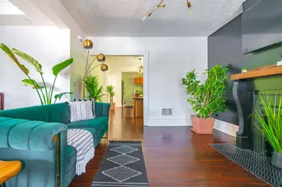 a living room with a couch and a fireplace at Jungle House Columbus Short North Downtown Free Parking - Steps to Convention Center & Nationwide Arena - 2BR Luxury Home - Sleeps 8 - Over 5,800 Five Star Stays in Columbus