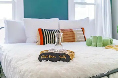 a glass vase on a bed with a basket on it at Jungle House Columbus Short North Downtown Free Parking - Steps to Convention Center & Nationwide Arena - 2BR Luxury Home - Sleeps 8 - Over 5,800 Five Star Stays in Columbus