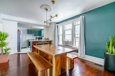 a kitchen and dining room with a wooden table at Jungle House Luxury Stays - Columbus Downtown Short North in Columbus