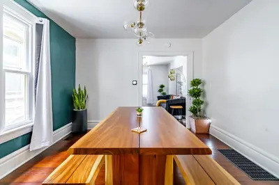 a living room with a wooden table in it at Jungle House Luxury Stays - Columbus Downtown Short North in Columbus